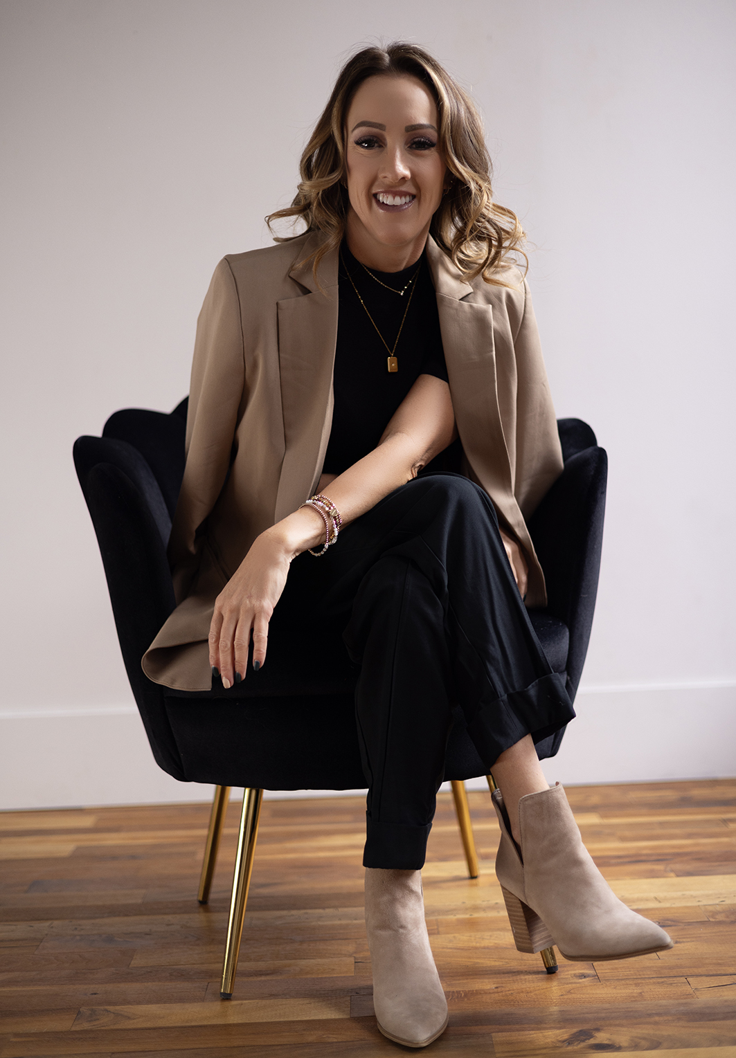 Image of Jennifer Belliston sitting in a chair with her arm draped across her knee